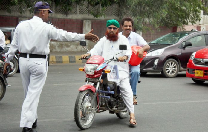 'No Helmet, No Entry' on Karachi's I.I Chundrigar Road